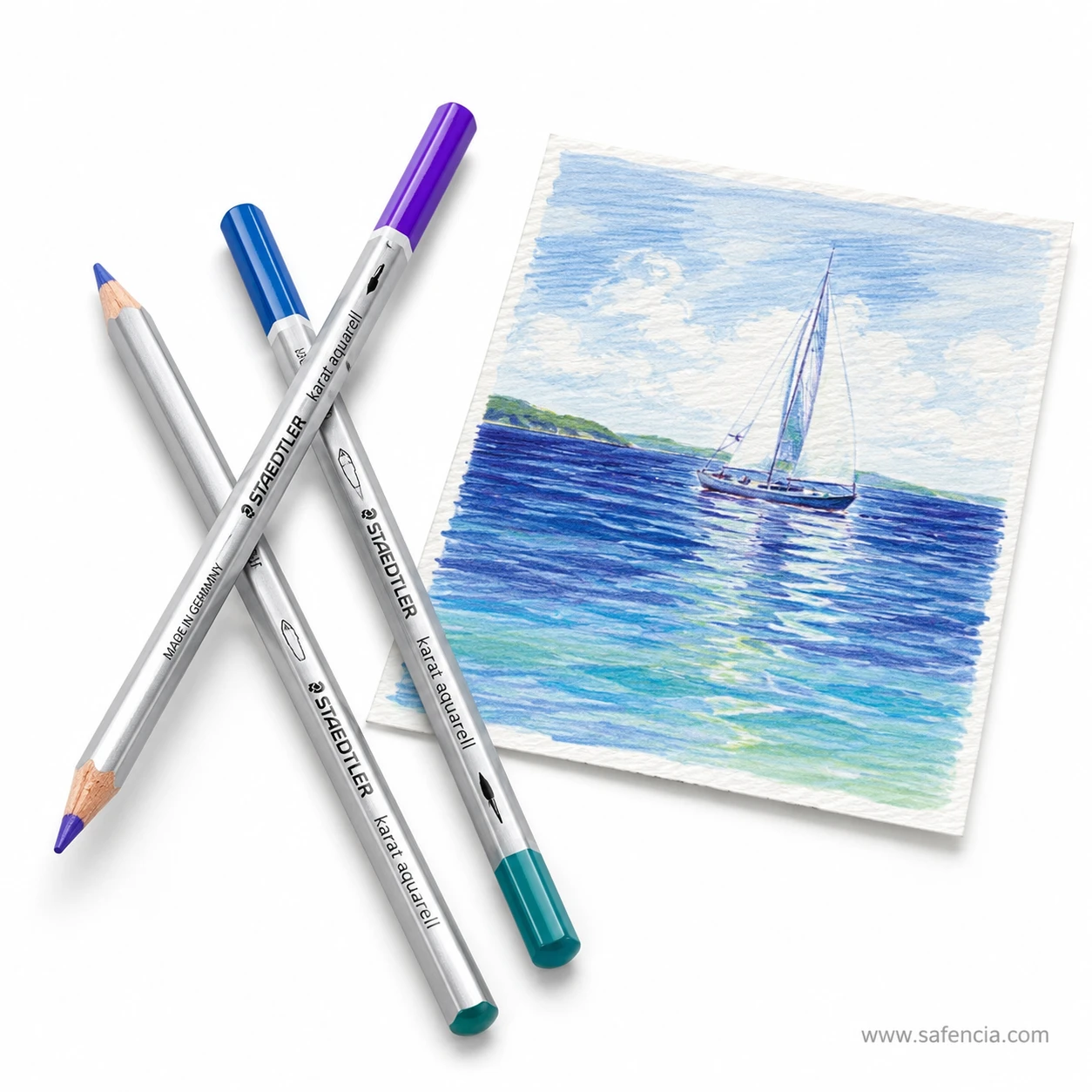 Two Staedtler Karat Aquarell pencils crossed over each other showing the pale silver barrel and the printed brand name