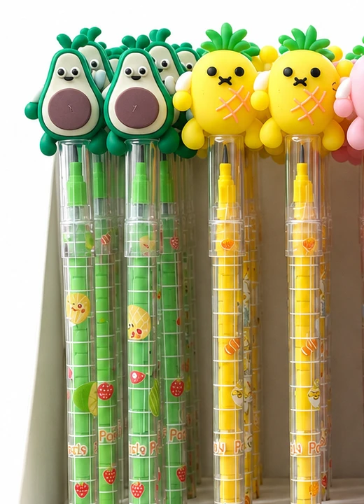 Close up of avocado and pineapple topper stacking pencils showing the clear barrels stacked with short pointed leads inside