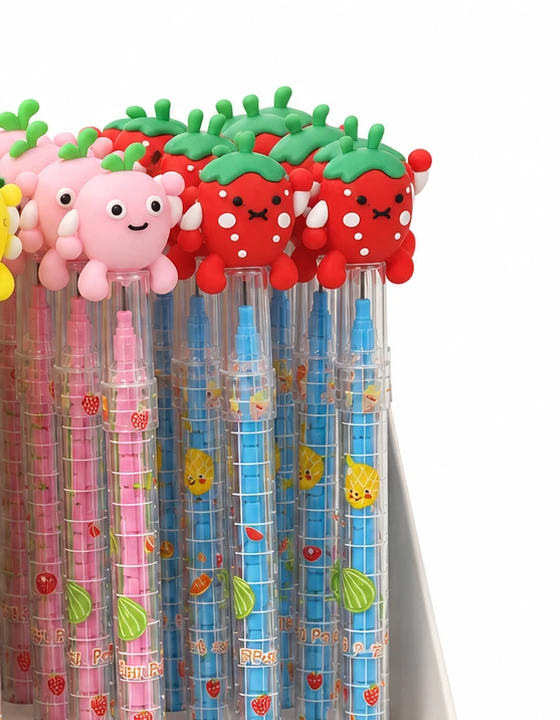 Close up of strawberry and pink character topper stacking pencils with fruit-patterned clear barrels on white