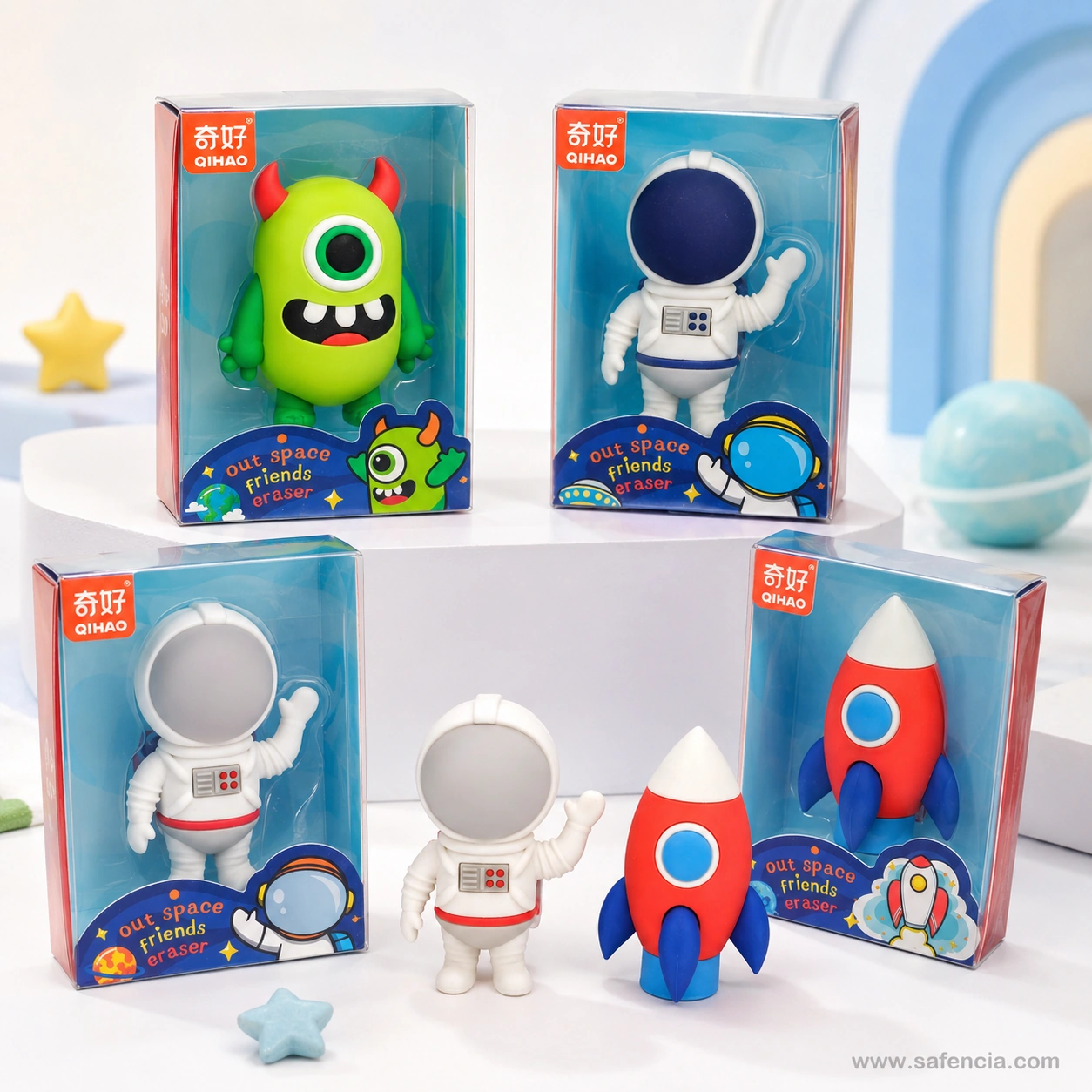 Qihao space eraser boxes arranged around a white pedestal with a loose astronaut and rocket in front and star erasers nearby