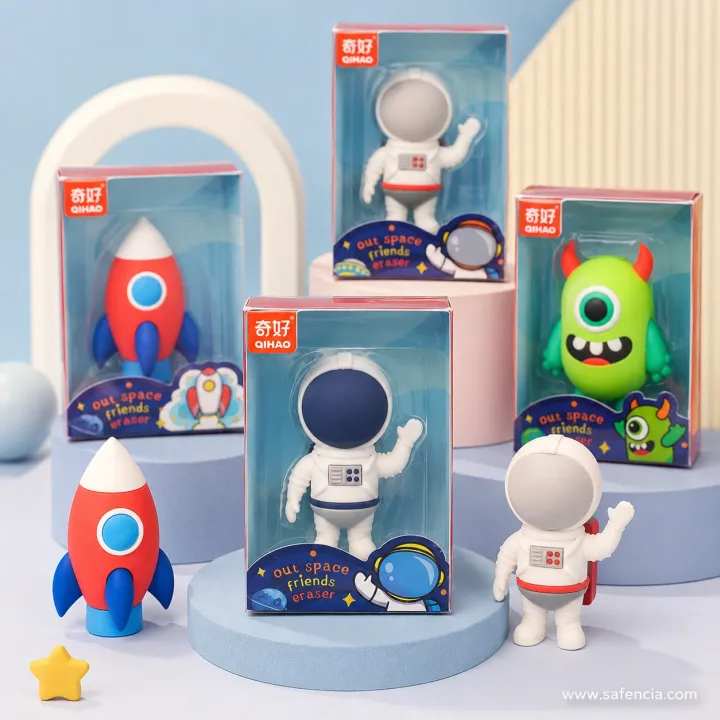 Space-theme erasers — rockets, astronauts and a green alien — on pastel display steps