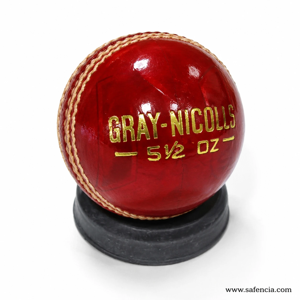 Shiny red 4-piece leather cricket hard ball showing gloss finish and stitching