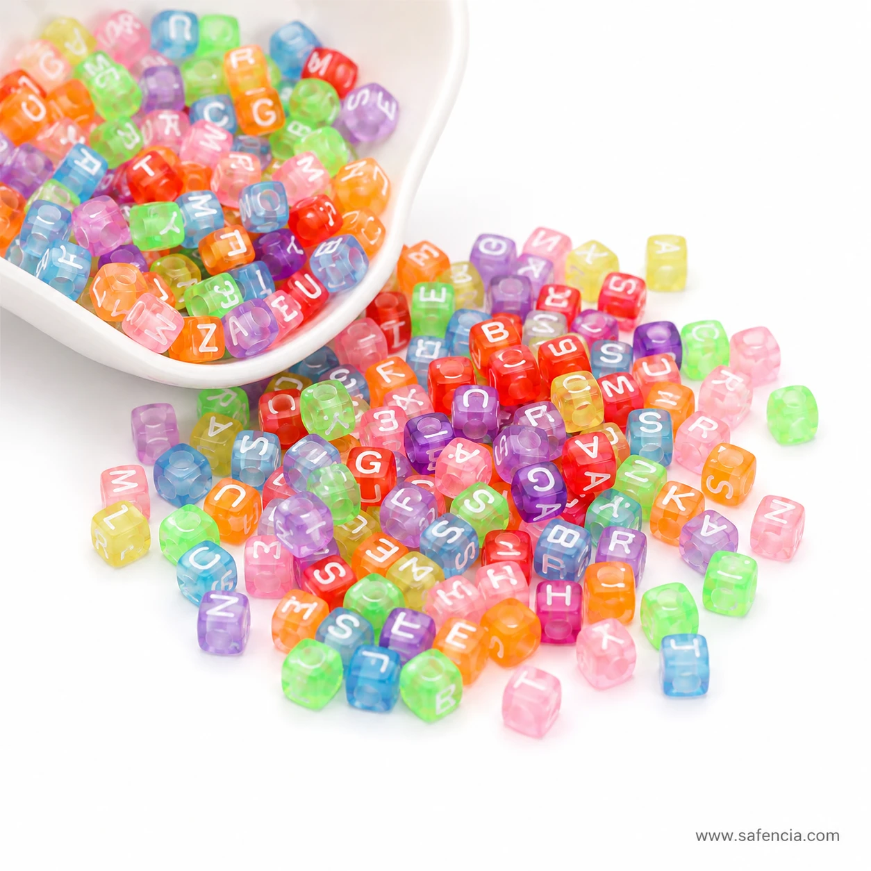Alphabet letter beads poured out of a white bowl onto a surface