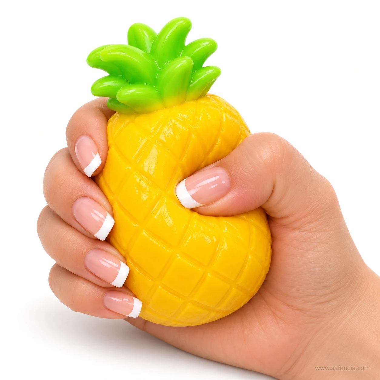 Hand squeezing the pineapple fruit squishy with the green crown sticking up out of the fist