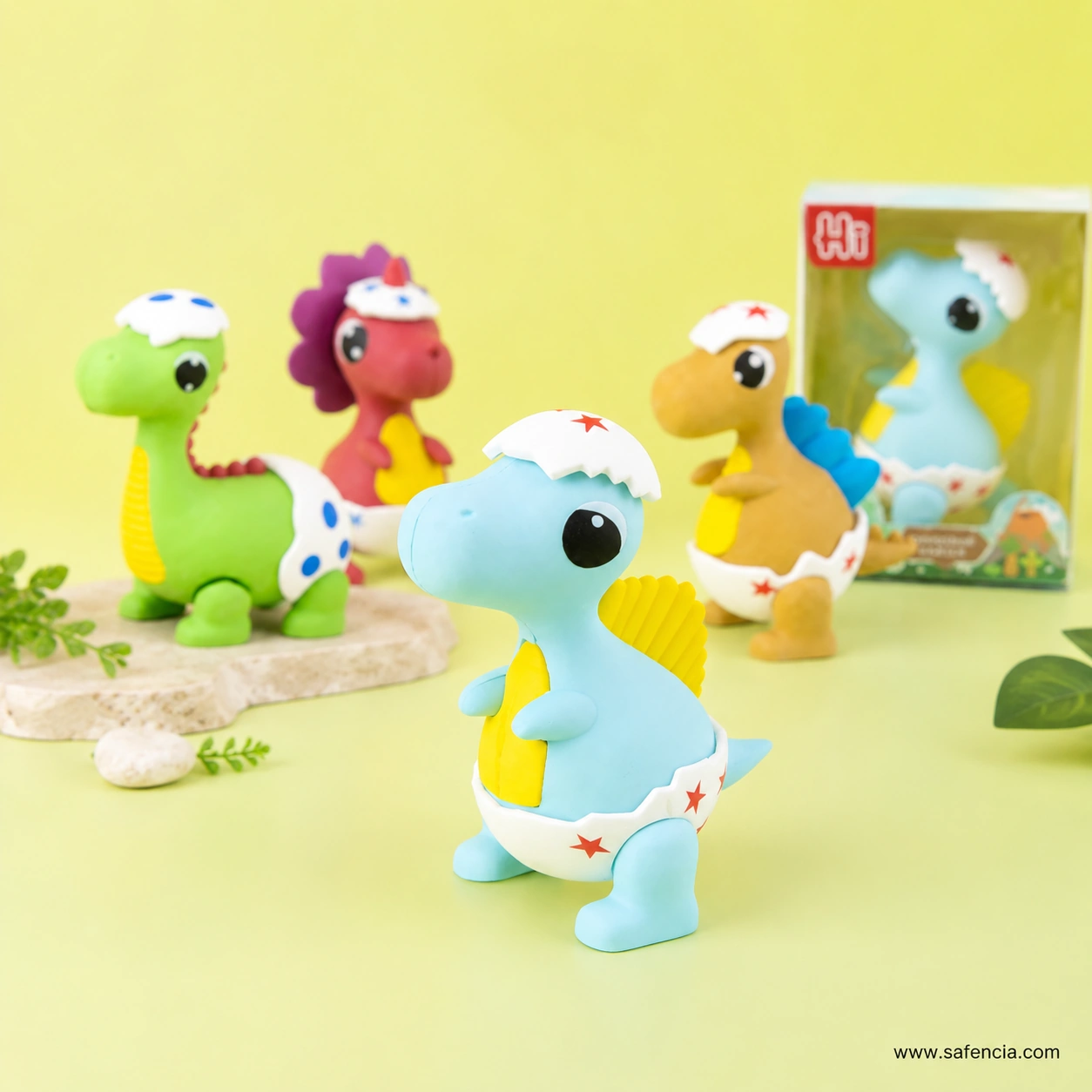 Blue baby dinosaur eraser standing in front, with the boxed version visible behind in its windowed Hi retail box