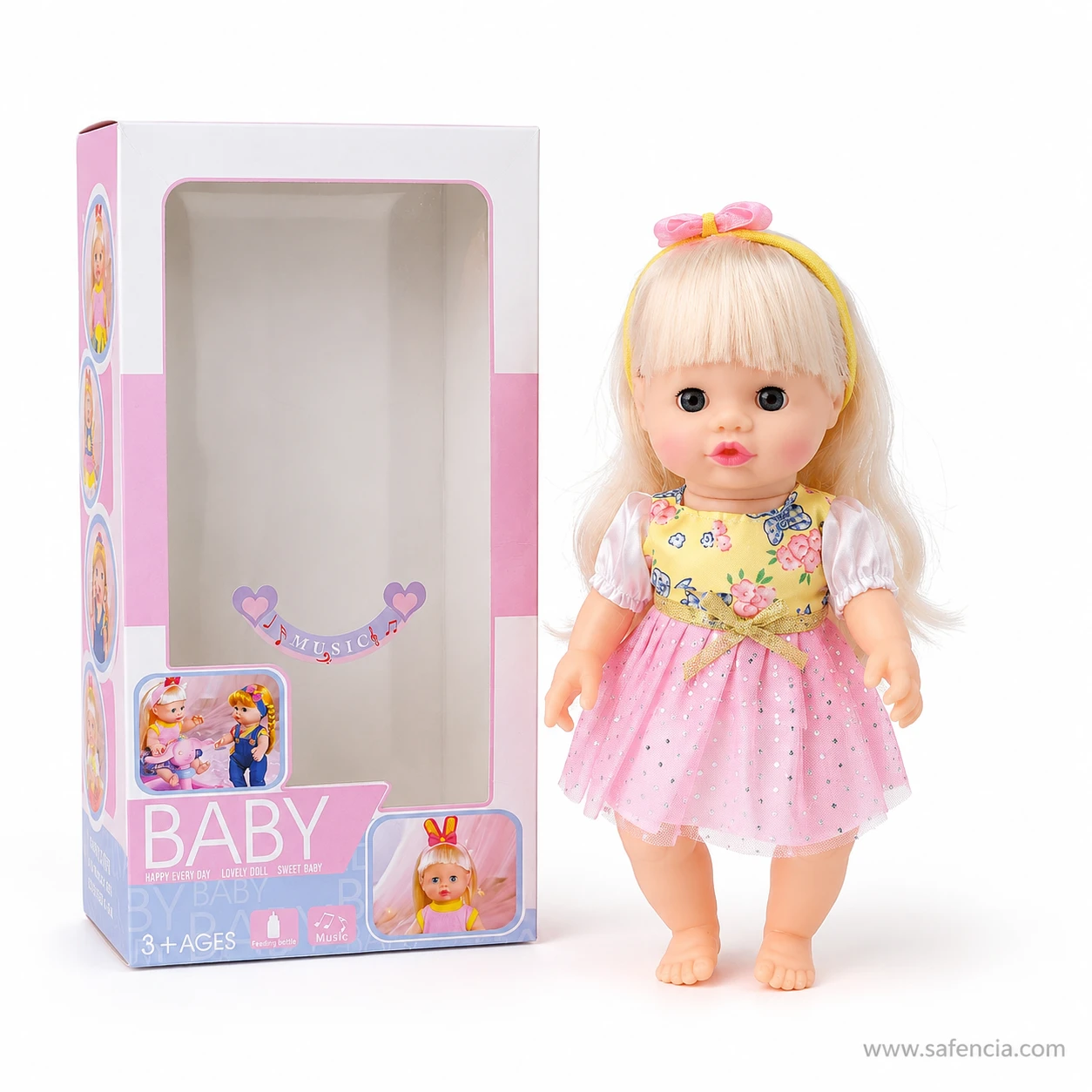 Musical baby doll standing beside her empty pink carton to show the doll's height