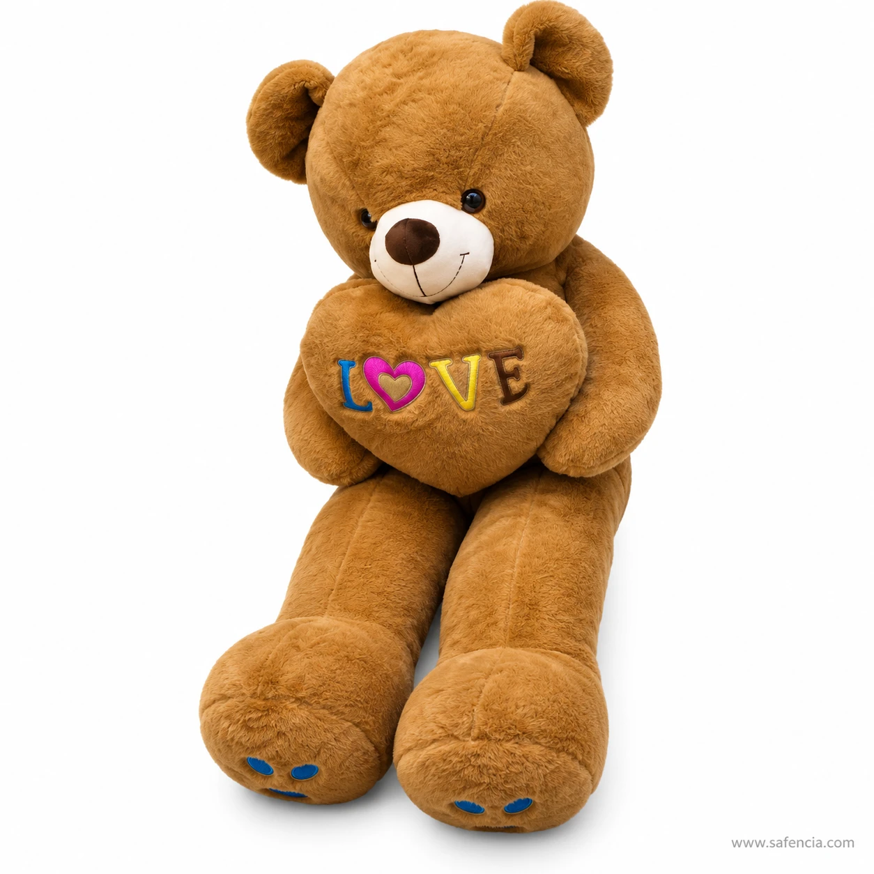 Brown love heart teddy bear seen from the side, showing its long plush legs and padded feet