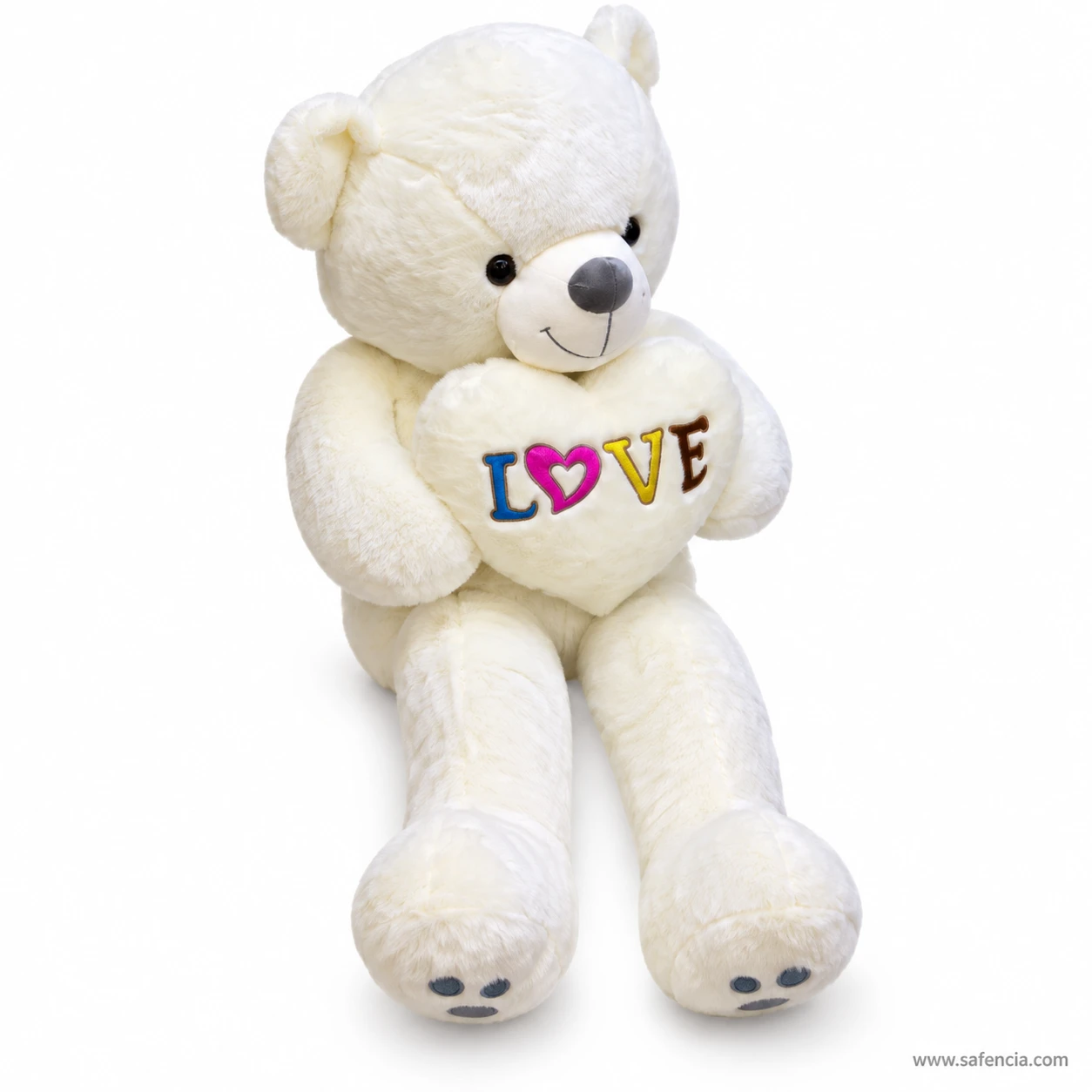 White love heart teddy bear from the side, hugging the LOVE heart high against its chest