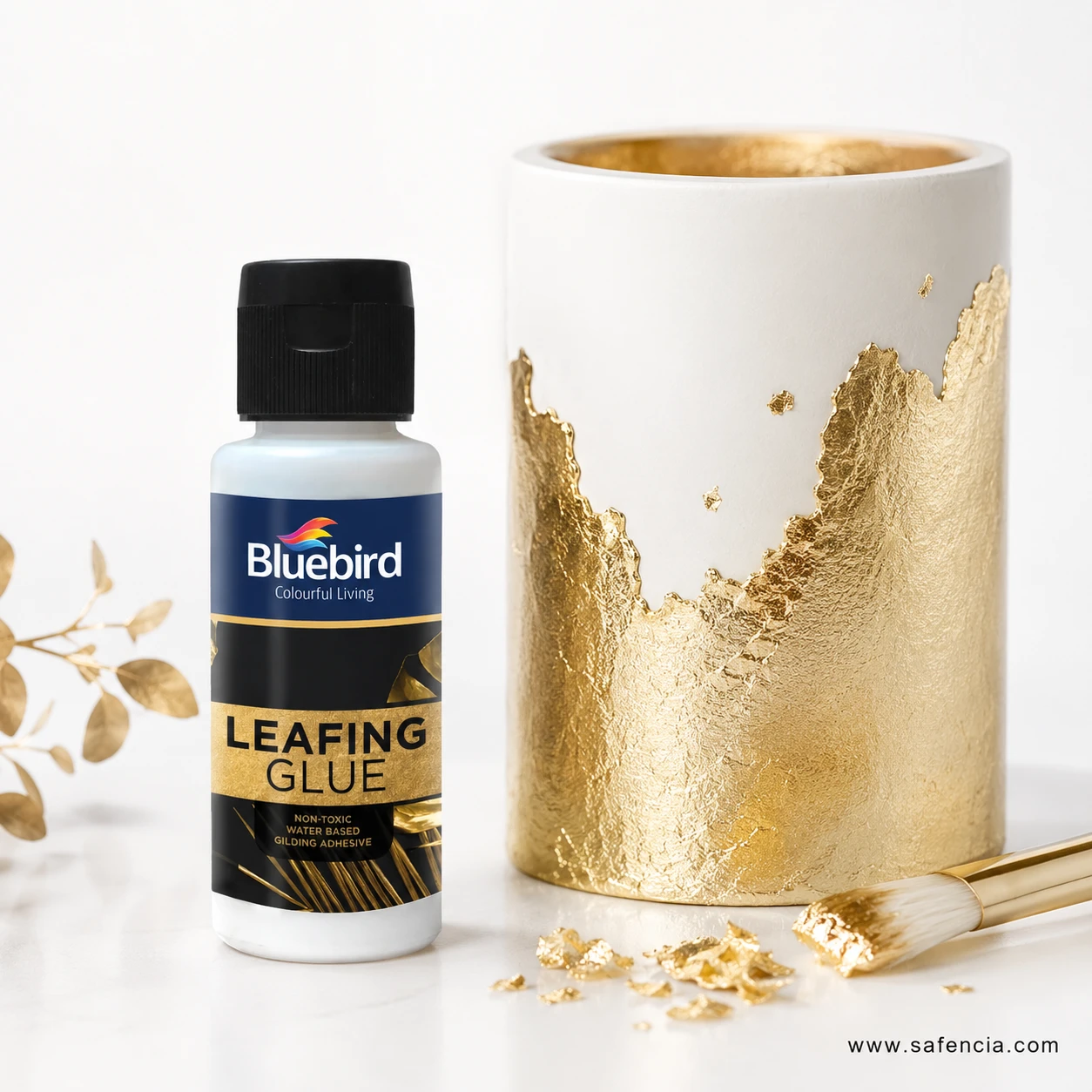 Bluebird Leafing Glue bottle beside white ceramic vase with brilliant gold foil leaf embellishment