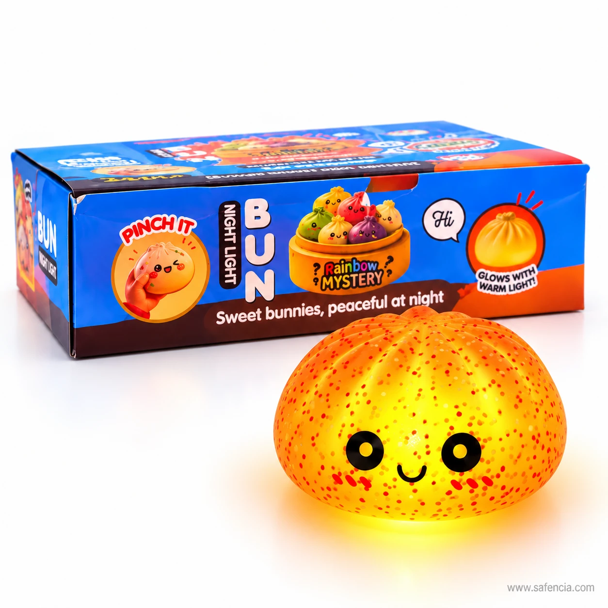 Glowing orange bun squishy night light sitting in front of its blue Pinch It box