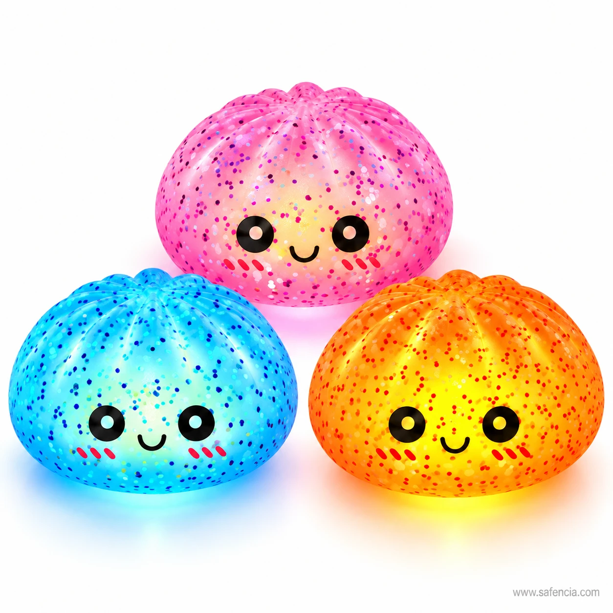 Pink, blue and orange bun squishy night lights glowing side by side with smiling faces