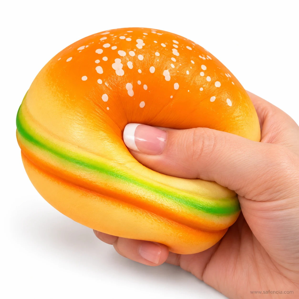 Hand squeezing the burger squishy so the top bun folds deeply under the thumb