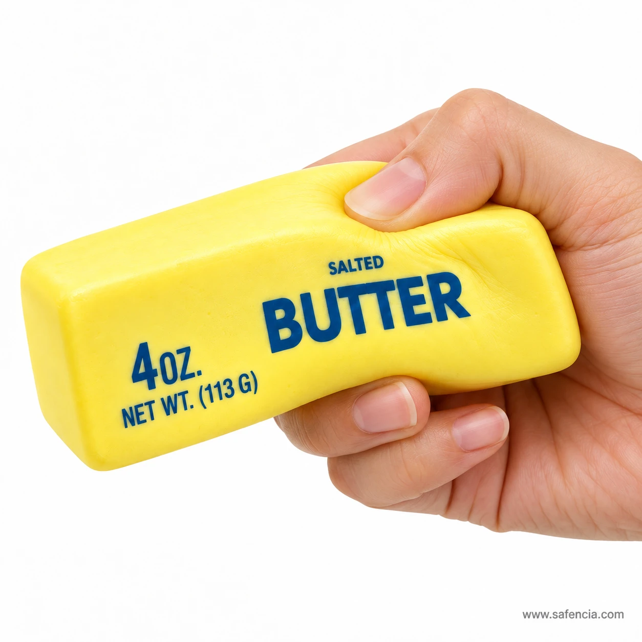 Hand squeezing one end of the yellow butter squishy so the slow-rising foam dents under the fingers