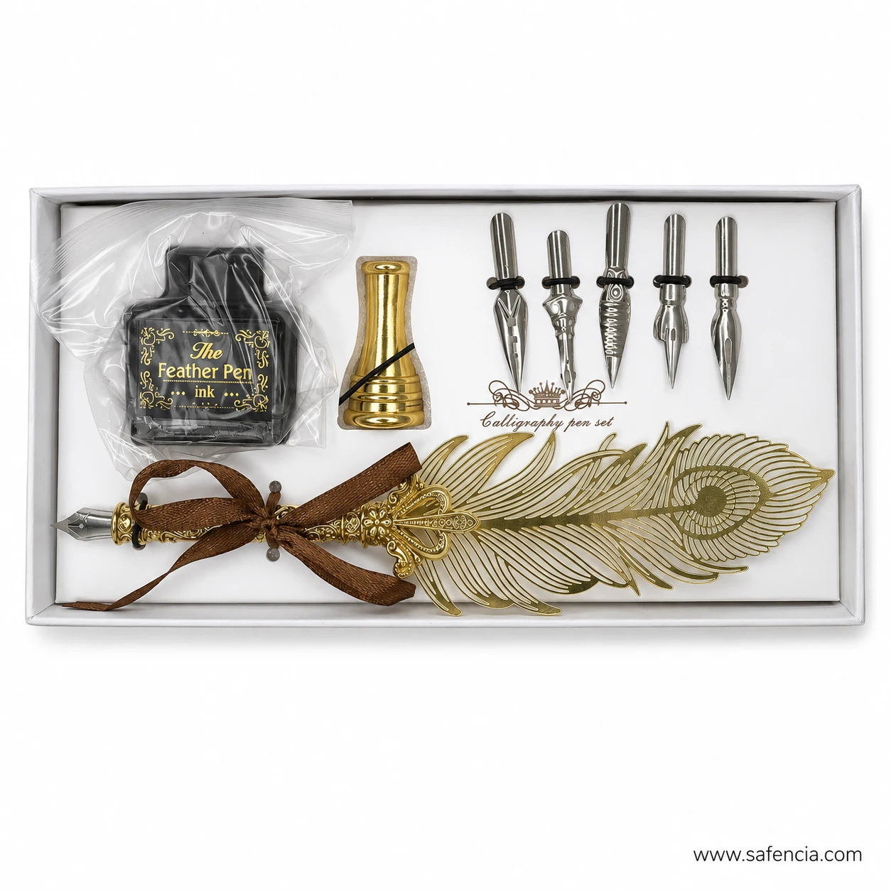 Close view of the tray showing the ink bottle, gold pen stand, five steel nibs and the gold feather pen