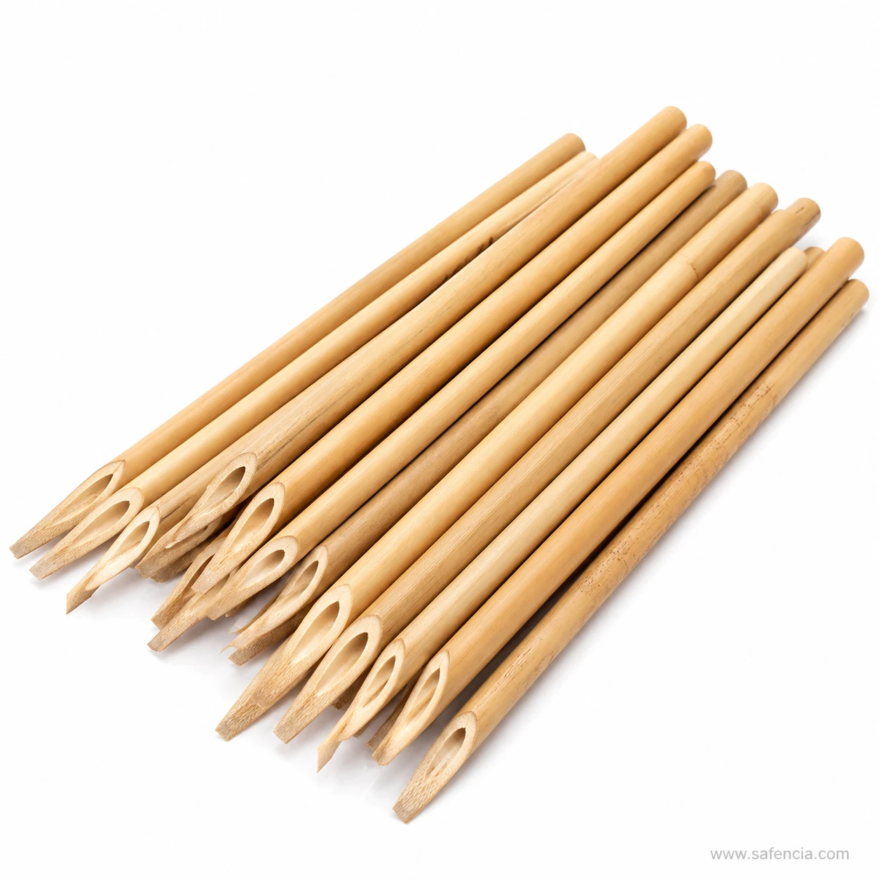 Loose bamboo qalams showing natural variation in cane shade, dark speckling and the occasional growth node