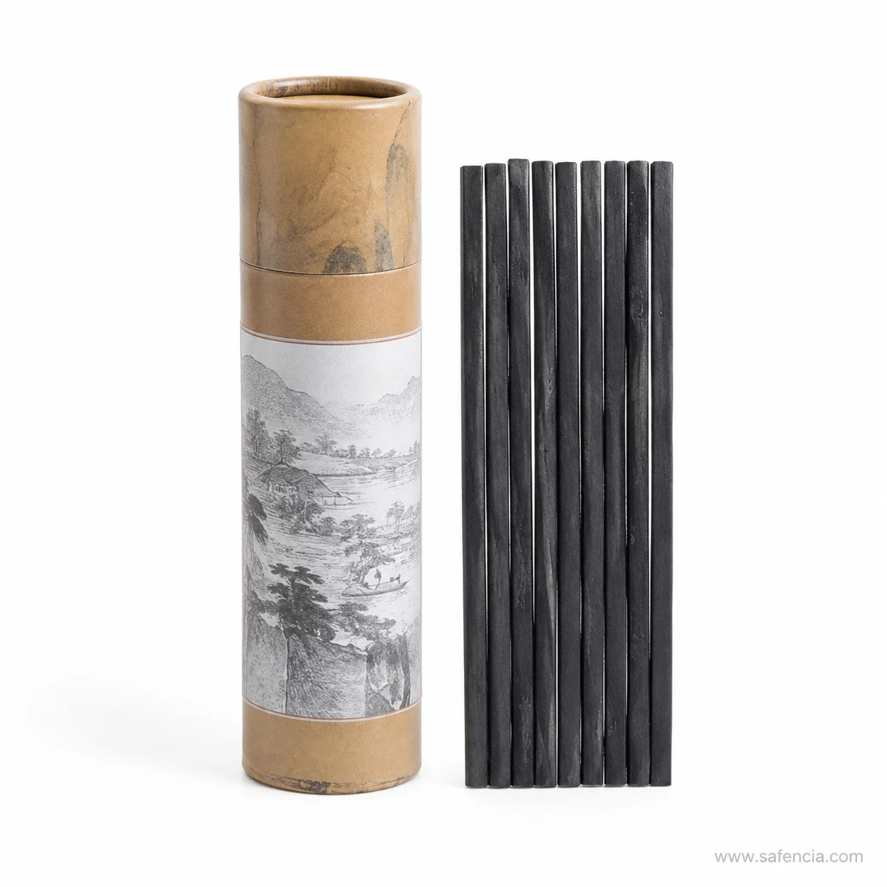 Paper tube of charcoal sticks standing upright beside a row of sticks
