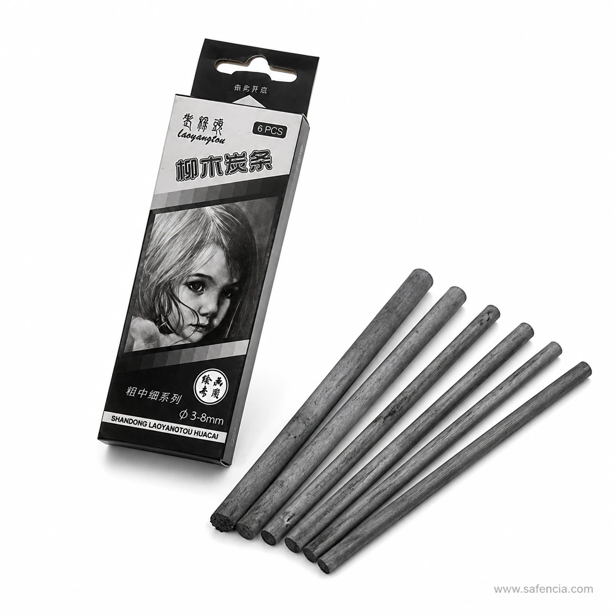 Willow charcoal sticks fanned out at an angle next to the printed card box