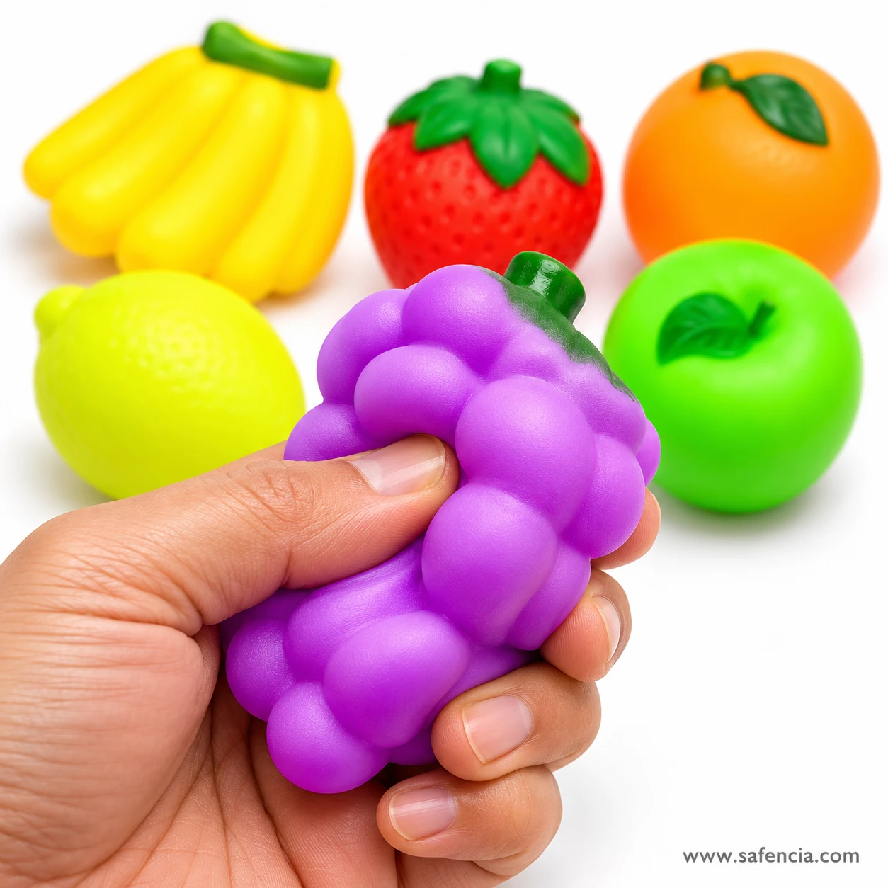 Hand squeezing the soft purple grapes from the chu chu fruit set to show how squashy it is