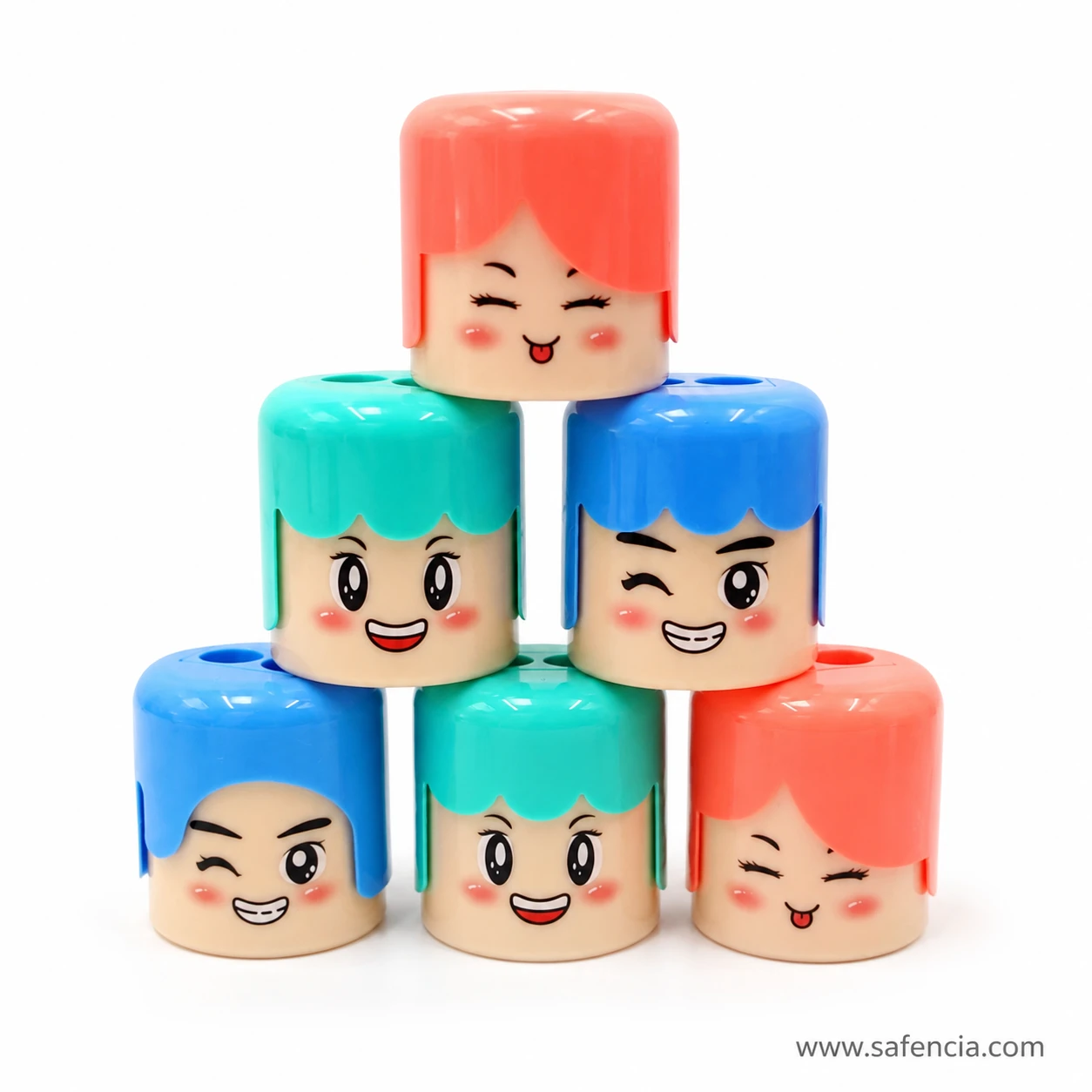 Group of cute double-hole cartoon pencil sharpeners in blue mint and coral with smiling faces