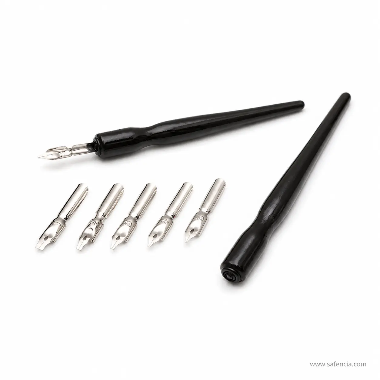The black Daler-Rowney dip pen laid beside its five nibs, showing the different nib shapes