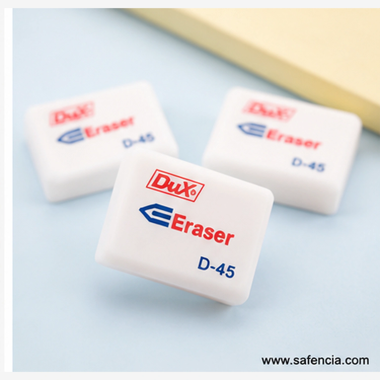 Close view of white Dux D-45 erasers packed in rows, each block printed with the Dux name in red, the word Eraser in blue and the D-45 code