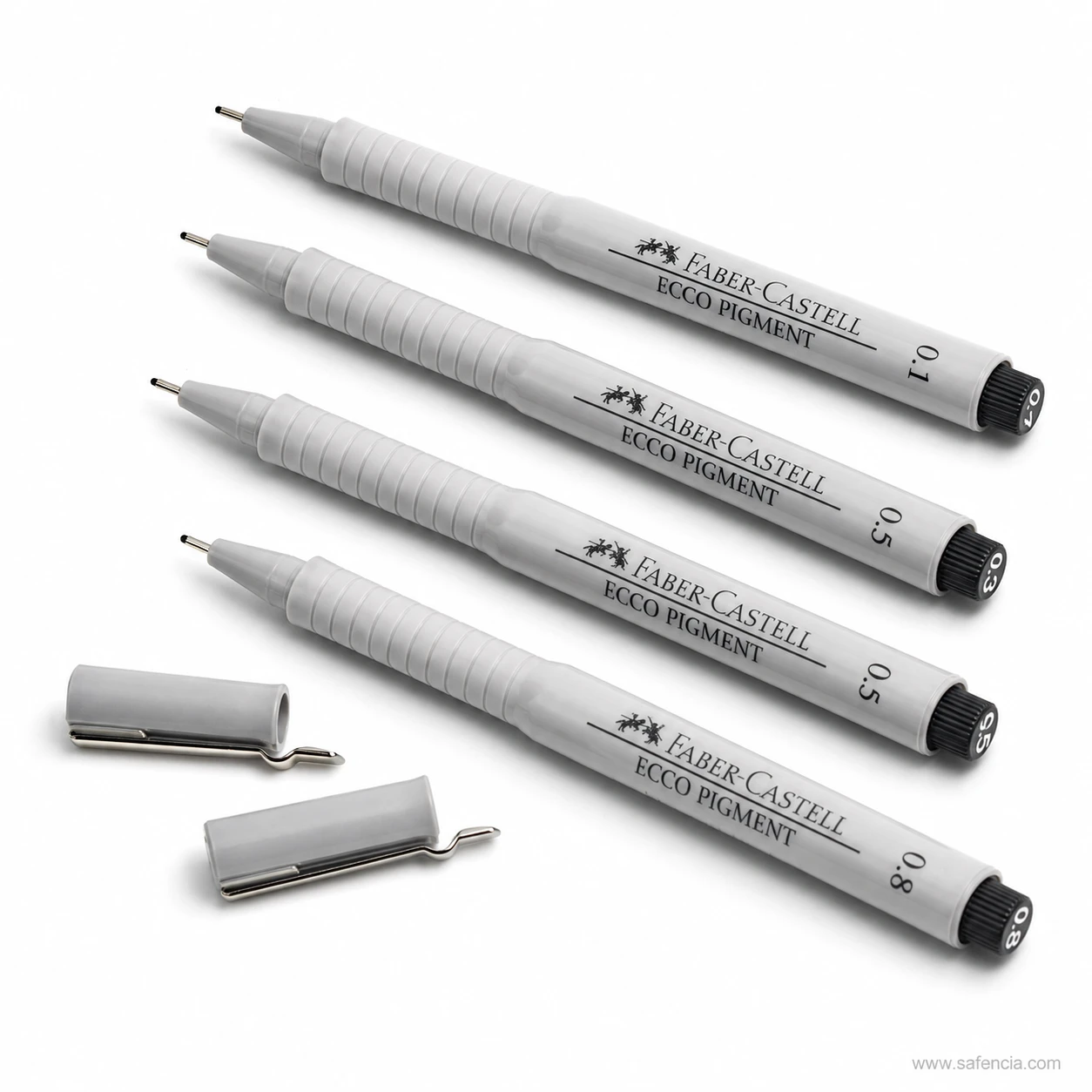Four Ecco Pigment fineliners uncapped beside two removed metal-clipped caps