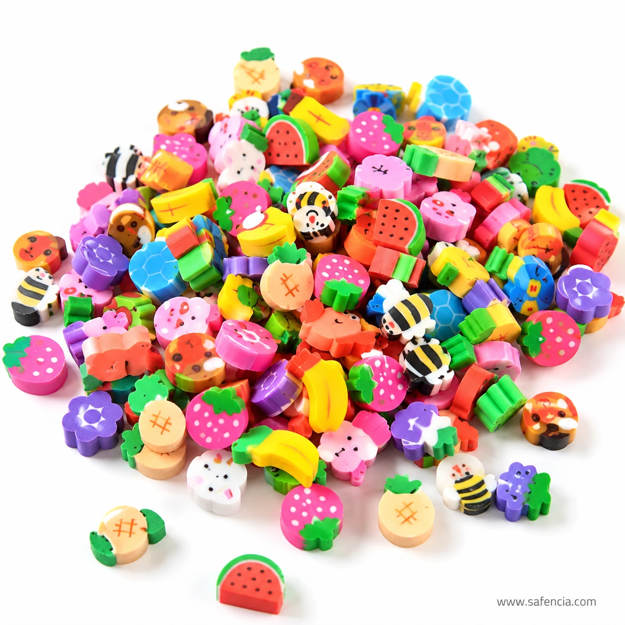 A heap of mixed miniature erasers showing watermelon, strawberry, bee, flower, cupcake and rabbit shapes in bright colours