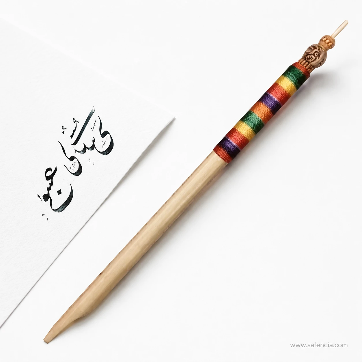 The fancy khatati qalam shown full length with its cut wooden chisel tip at the writing end