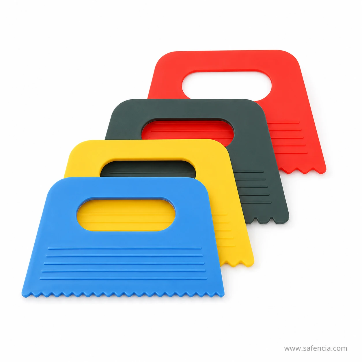 Four scraper combs stacked showing the moulded handle cut through each blade