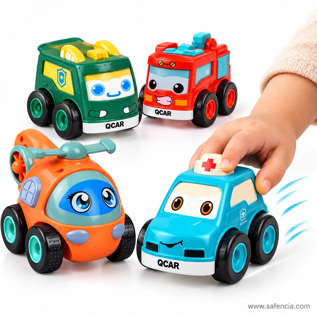 Child's hand pushing the blue ambulance friction toy car forward beside the police van, fire truck and helicopter
