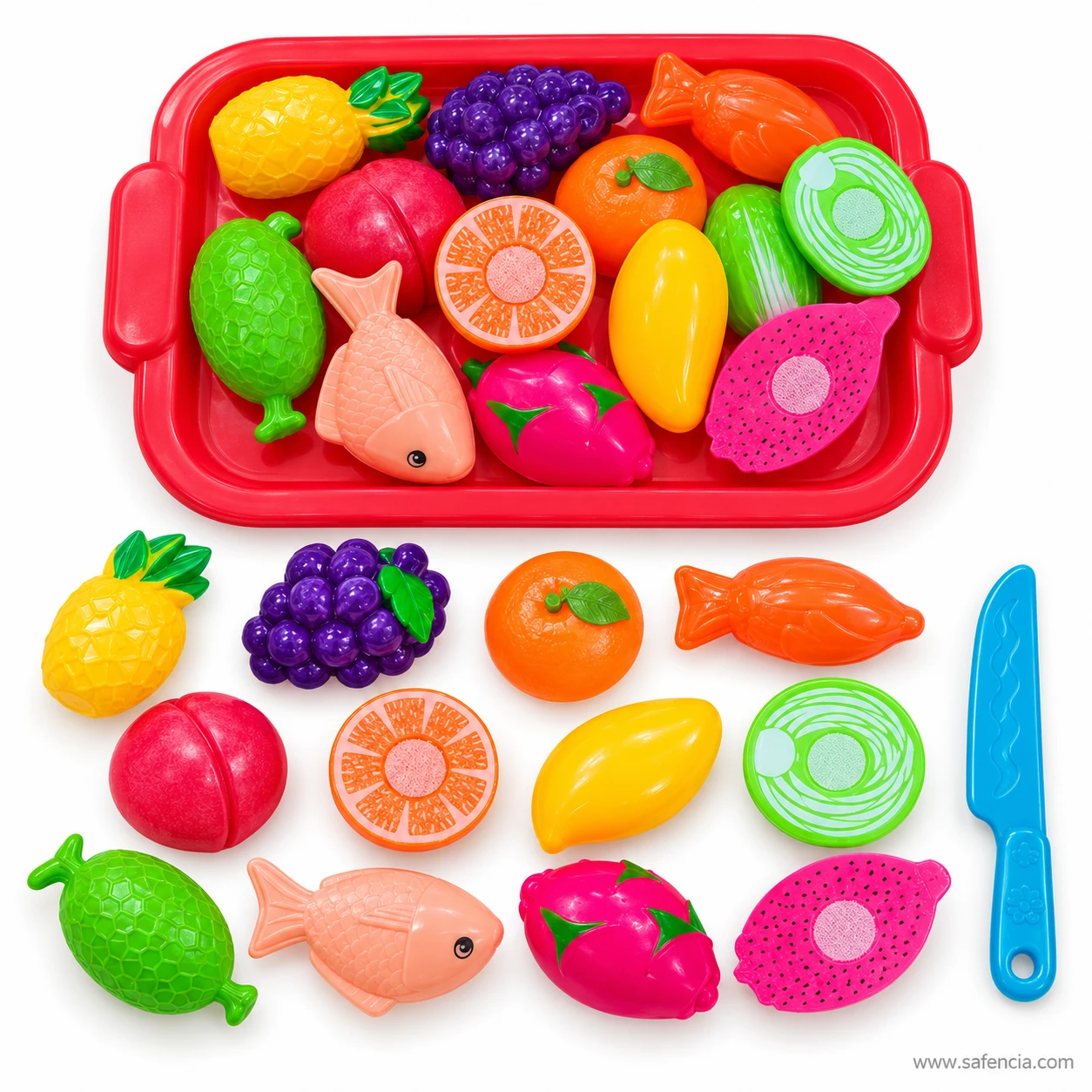 Fruit and fish cutting set pieces laid out below the tray: pineapple, grapes, orange, carrot, apple, mango, fish and knife