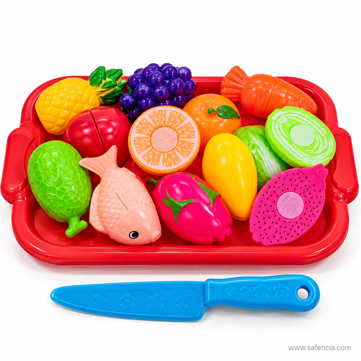 Red tray filled with play pineapple, grapes, carrot, orange, mango, dragon fruit and a pink fish, with a blue toy knife