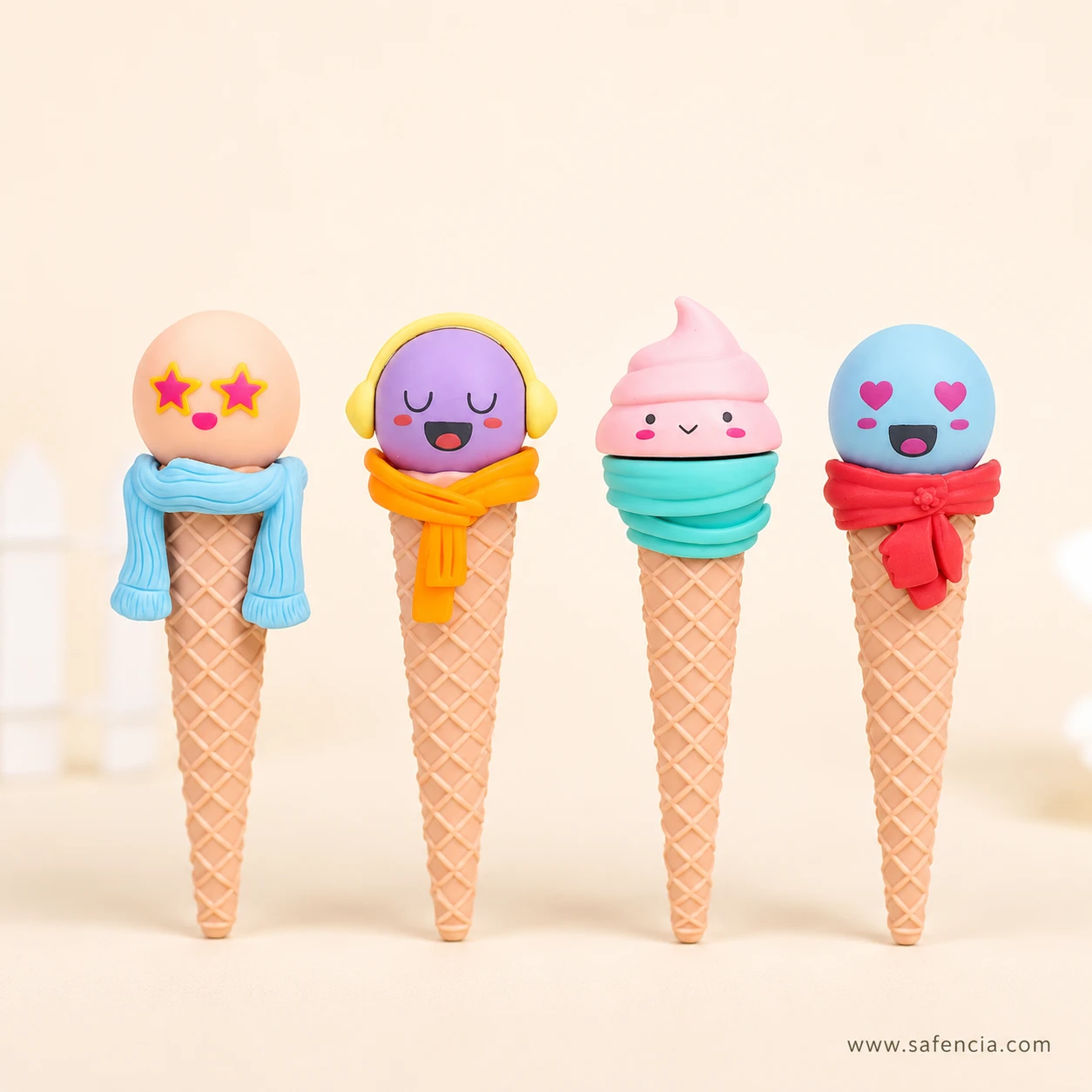 Front-on line-up of the four funny face ice cream erasers on a cream background showing each printed face in detail