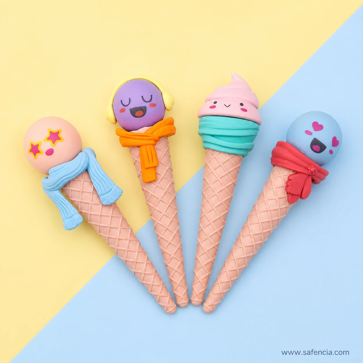 Overhead view of the four funny face cone erasers fanned out on a yellow and blue background showing their full length