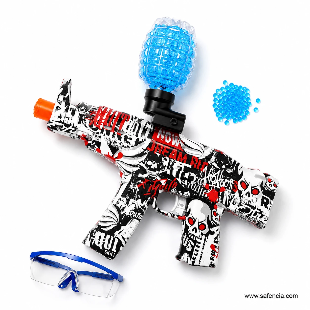 Overhead flat lay of the gel ball blaster beside a large pile of blue gel balls and safety goggles