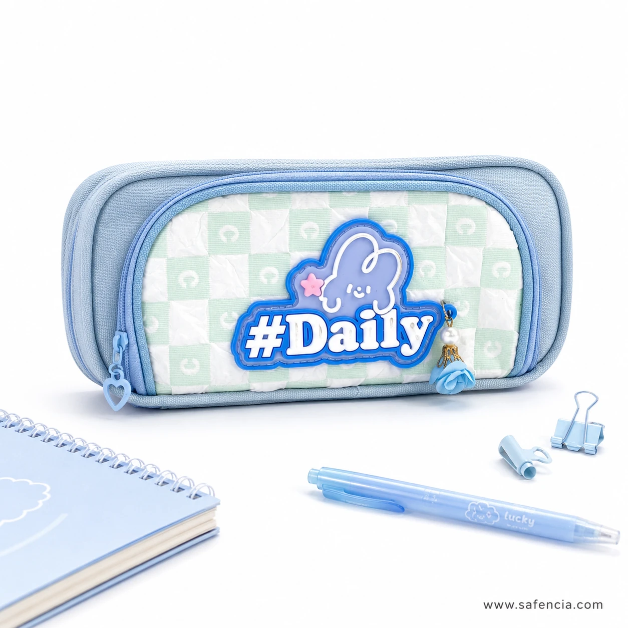 Daily bunny checkerboard pencil case beside a notebook and blue pen