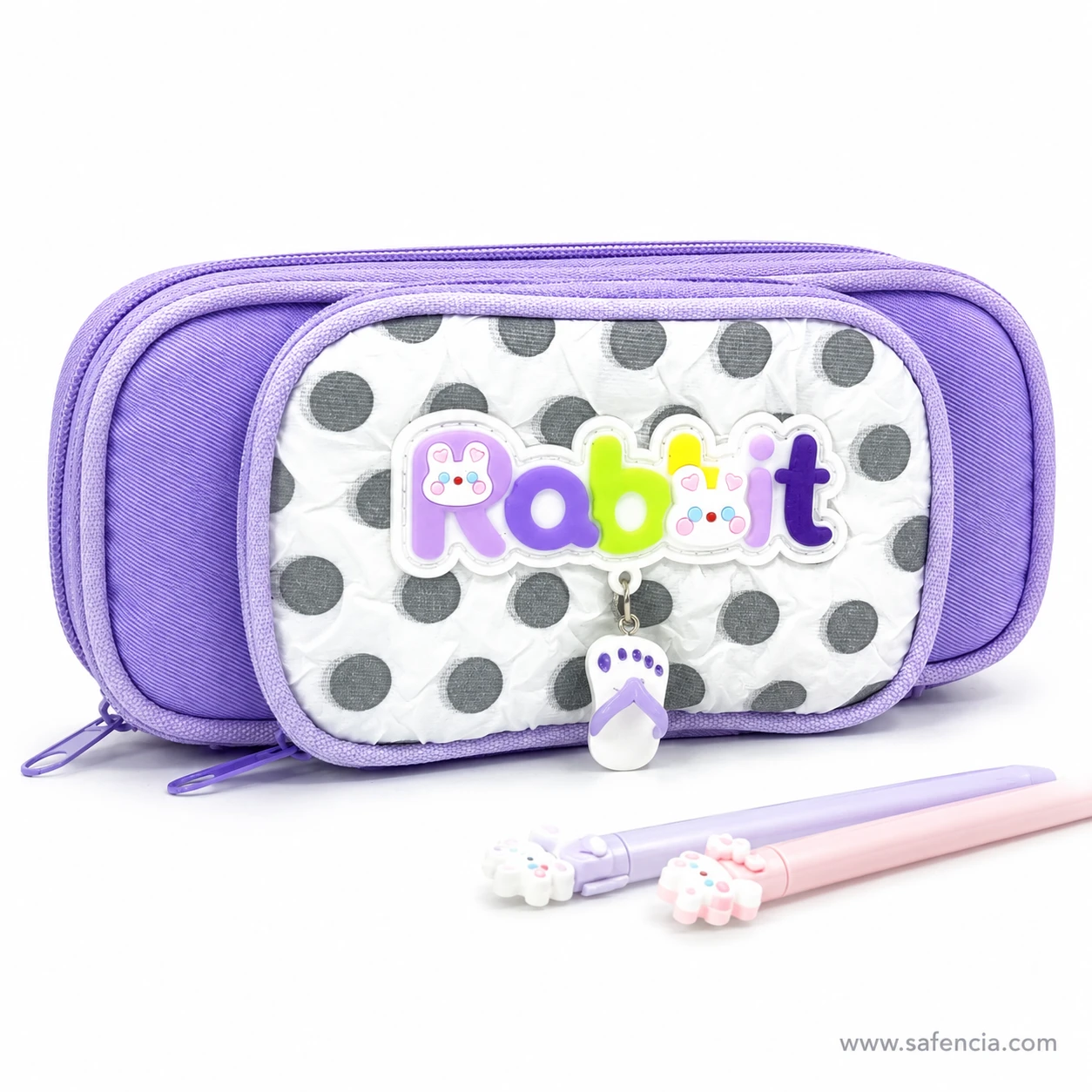 Rabbit polka dot pencil case beside pastel pencils showing its scale
