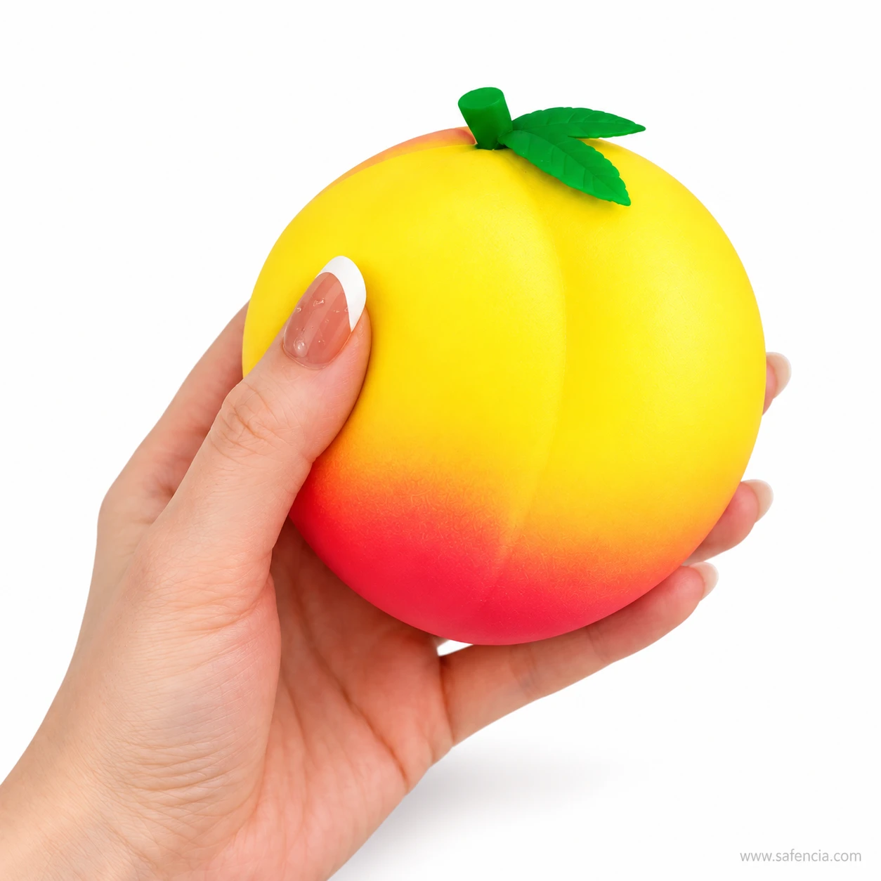 Honey peach squishy resting in an open palm showing its size against an adult hand