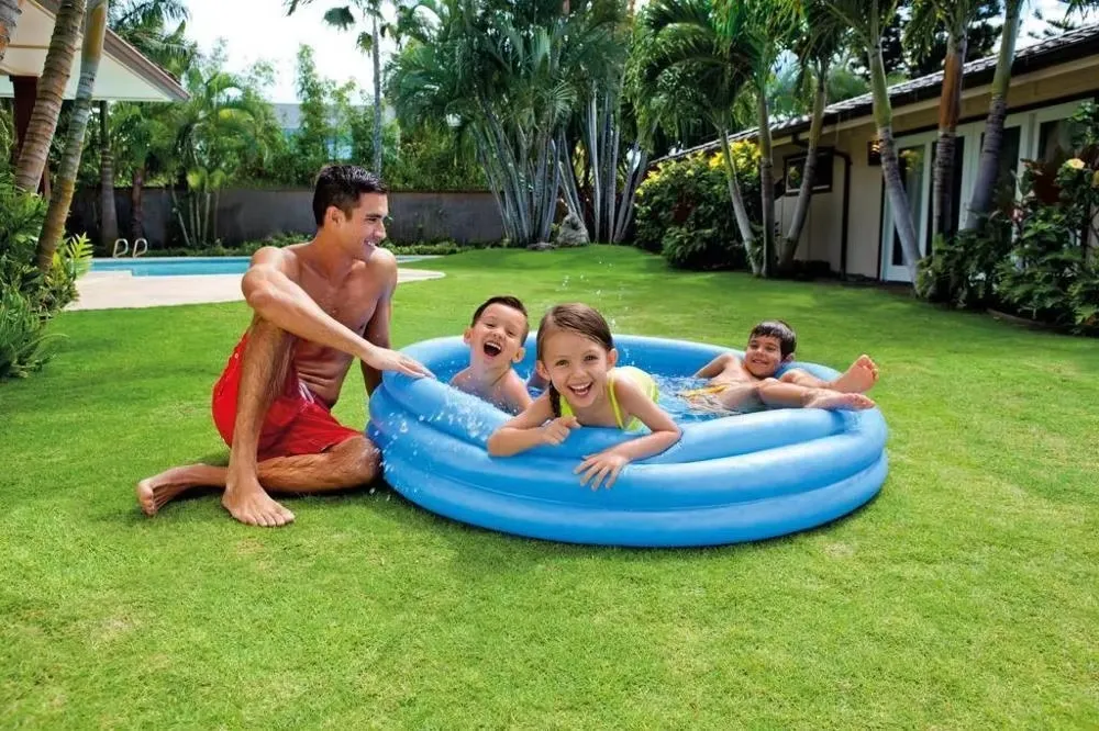 Intex Crystal Blue Pool shown on a lawn with children using a blue inflatable pool