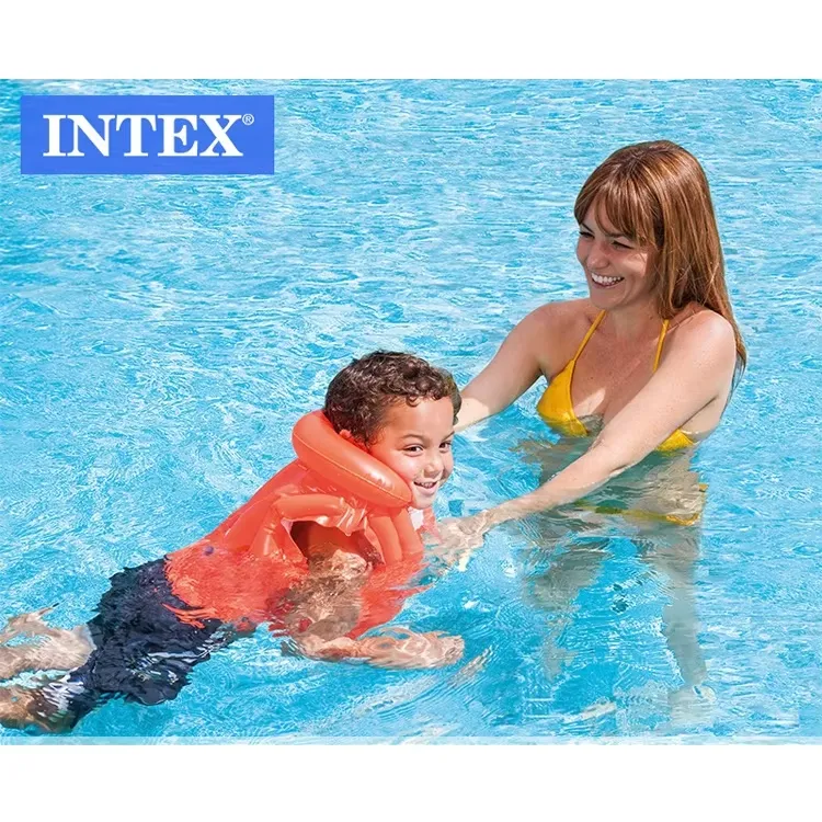 Child wearing an orange Intex Deluxe Swim Vest while learning to swim with adult support