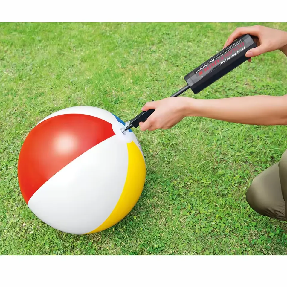 Intex Double Quick Mini Hand Pump 69613 being used to inflate a beach ball