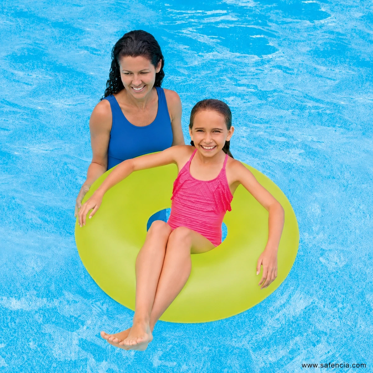 Child seated in lime 30-inch Intex Fluorescent Swim Ring 59260 in blue pool water