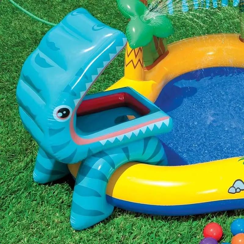 Close-up of the Intex Little Dino blue dinosaur head with an open mouth ball game beside the pool