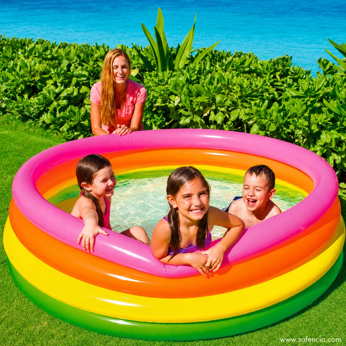 Children splashing in the deeper Intex Sunset Glow round pool in a home garden