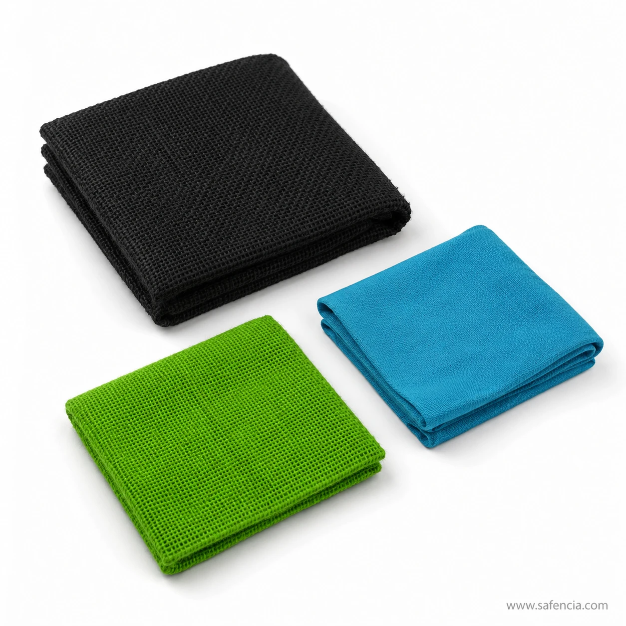 Angled view of folded jute cloth colour pieces in black, green and blue