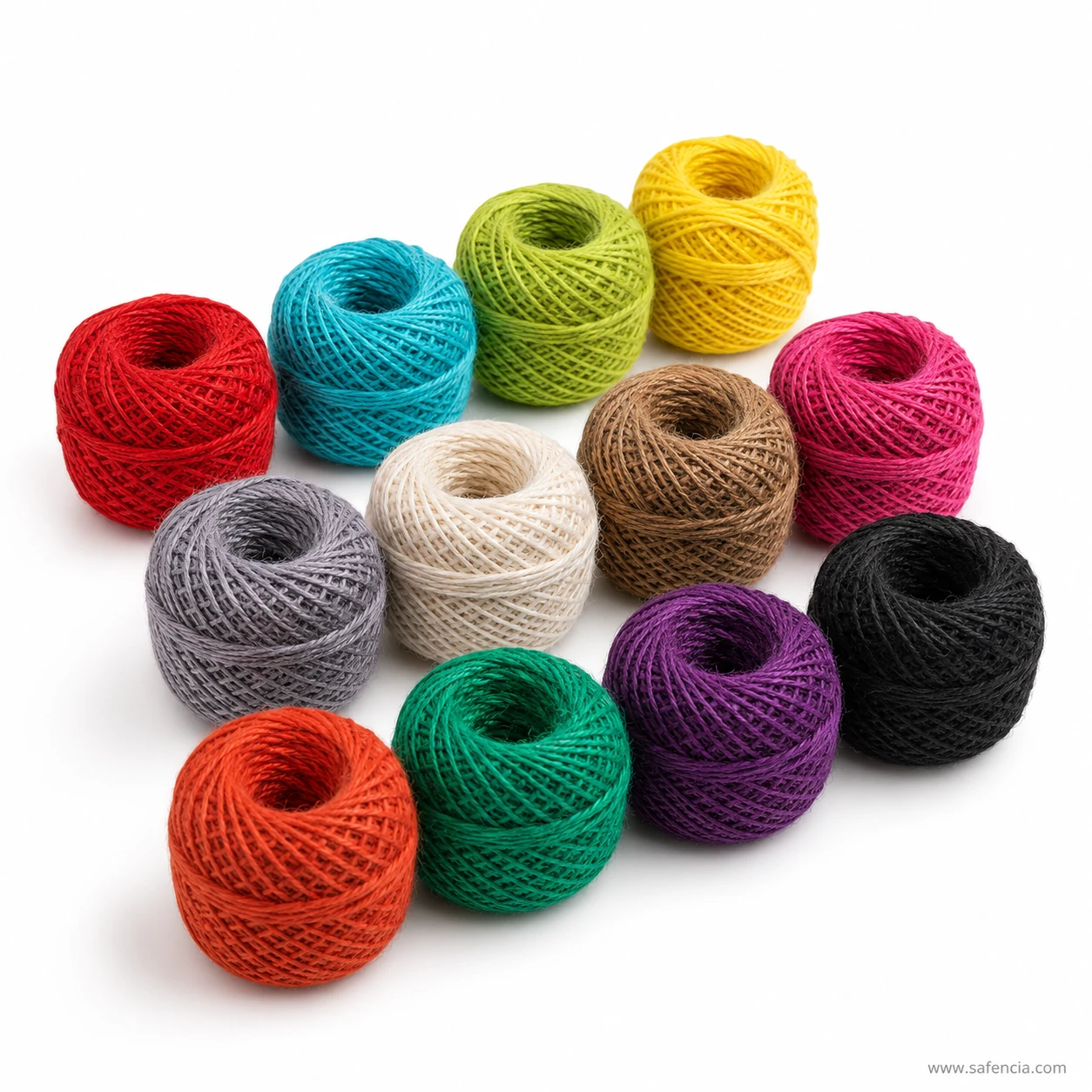 Small coloured jute balls stacked showing how tightly each is wound