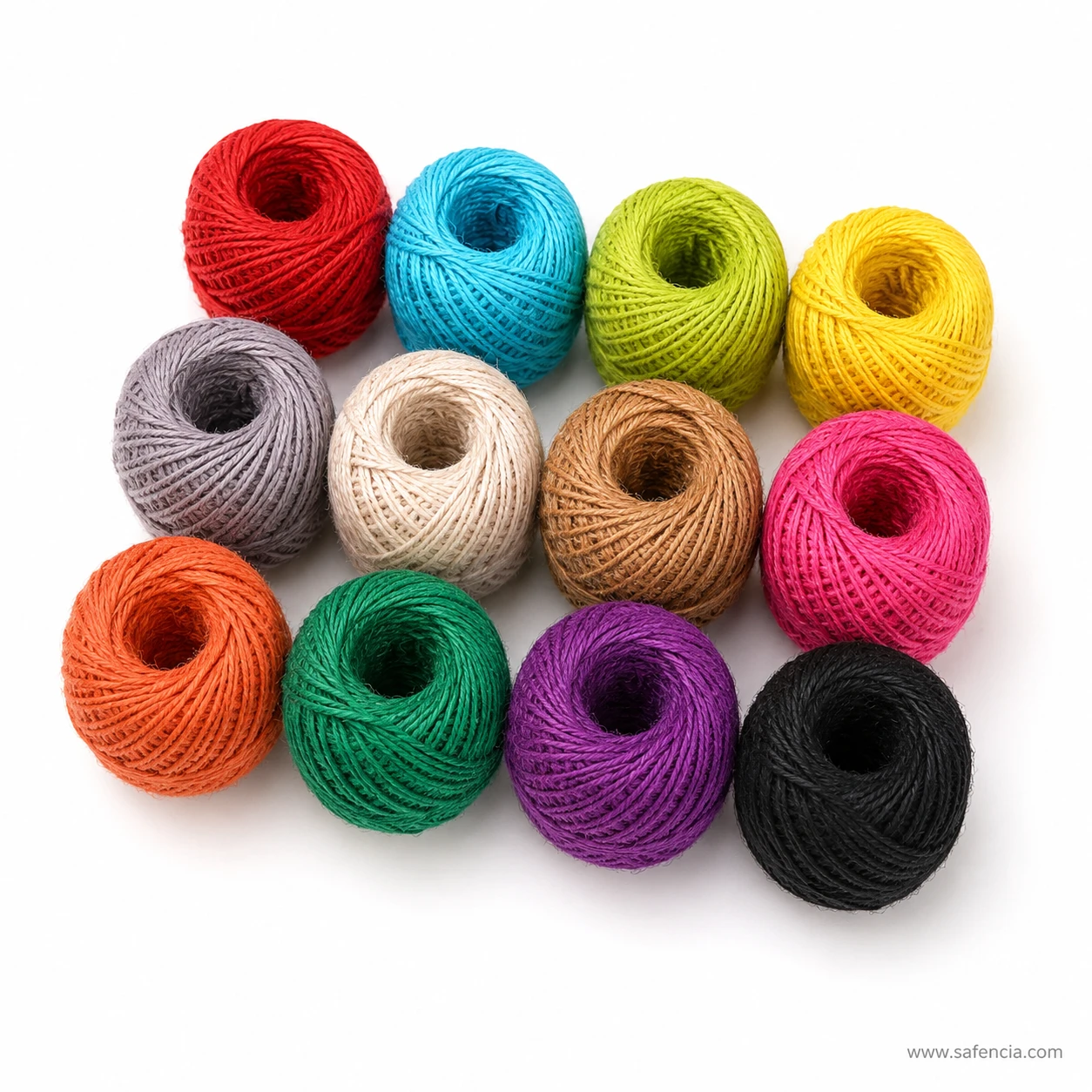 Coloured jute twine balls arranged loosely showing the dyed fibre