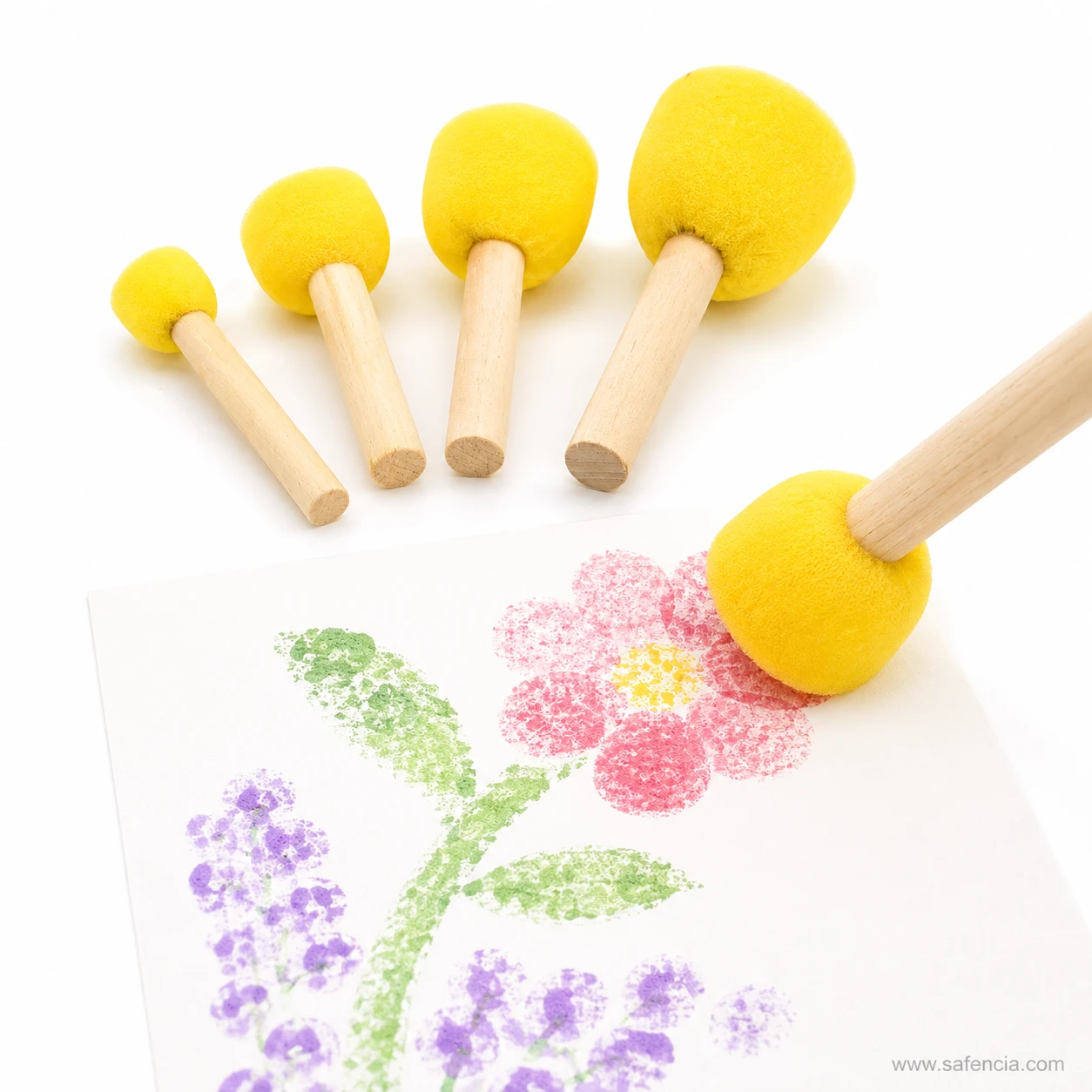 Round dabber foam brush stamping dots to paint a flower with petals and leaves