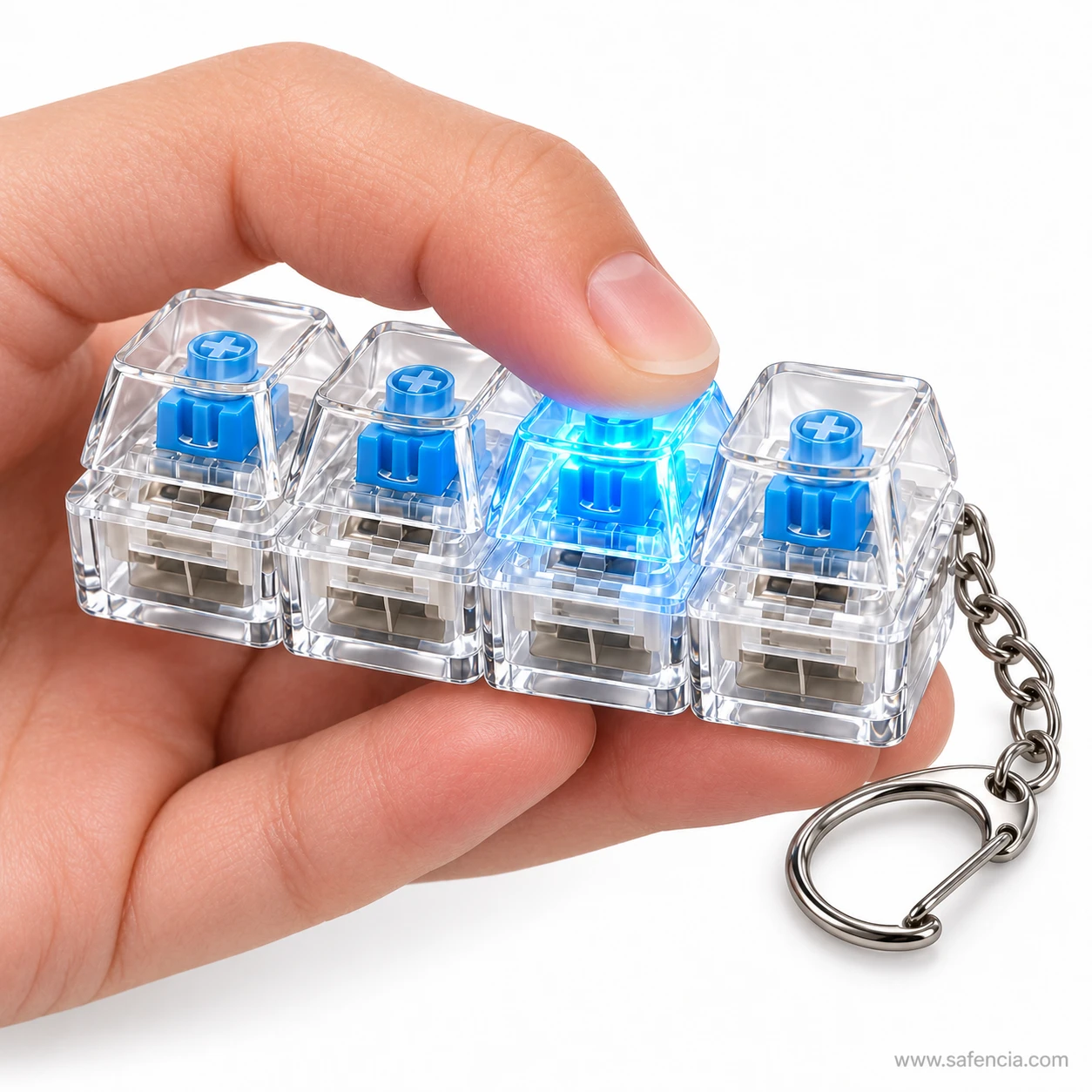 Keyboard clicker keychain held in one hand while a thumb presses a glowing blue key