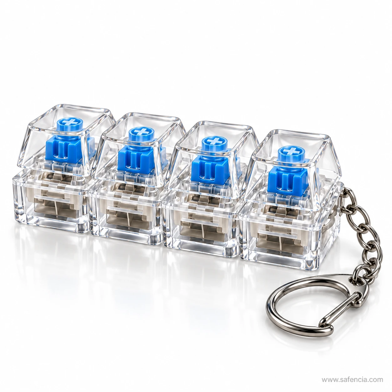 Keyboard clicker keychain resting on a white surface with its reflection and metal clasp visible
